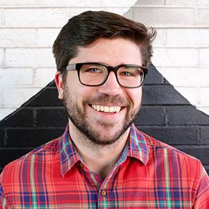 Ryan Gerhardt, bearded speckled man, smiles at the camera