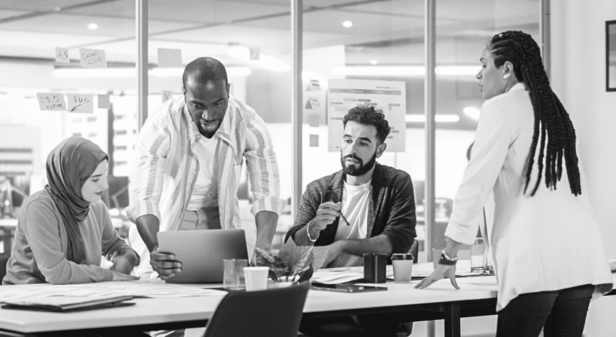 A group of people working together in an office setting.