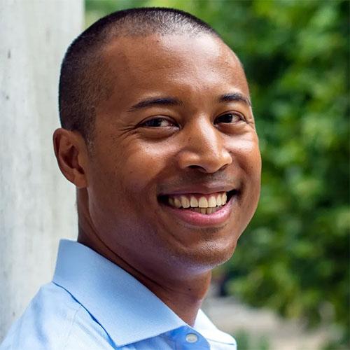 Headshot of Alix Guerrier, CEO, DonorsChoose, in a light blue shirt.