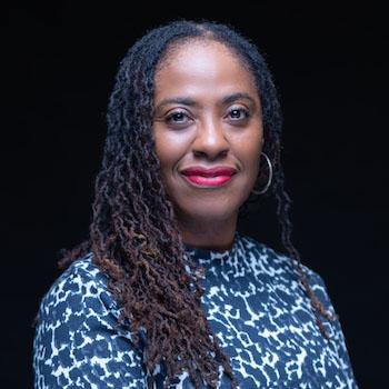 Headshot of Sharon Bush, president of the Grand Victoria Foundation, in a blue and white top.