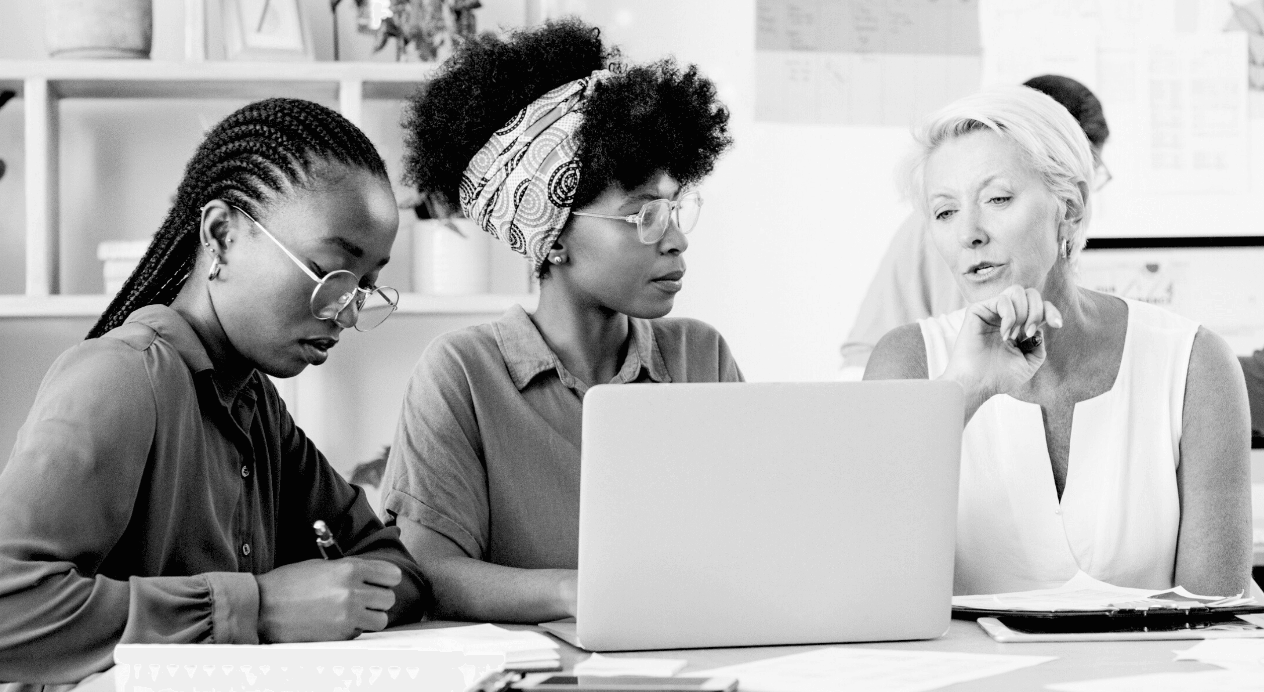 Three women collaborating on a project.