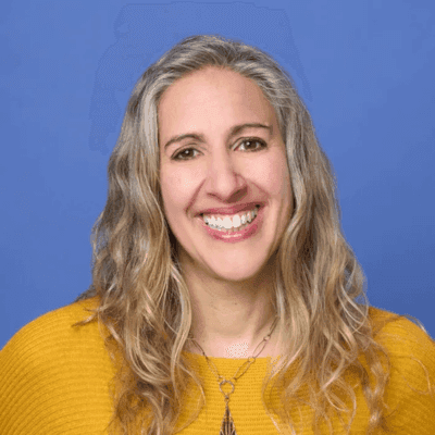 Headshot of Bess Rothenberg, senior director of strategy and learning at the Ford Foundation, in a yellow top.