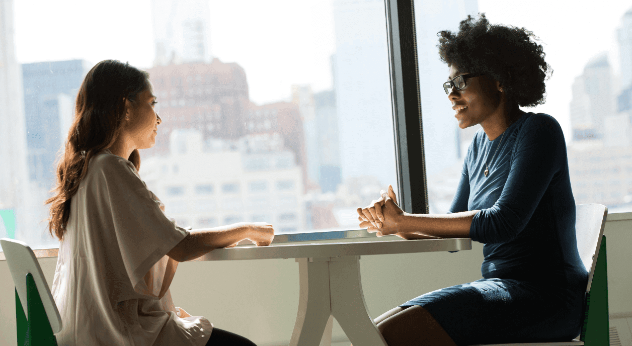 Two colleagues discussing nonprofit stories.