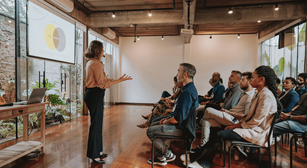 A nonprofit CEO speaking in front of staff.