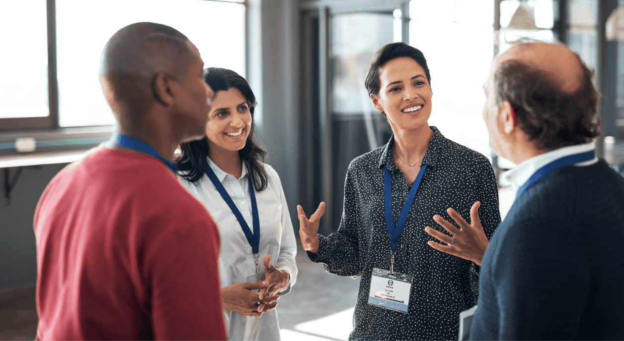 Fundraisers talking to potential donors at an event.
