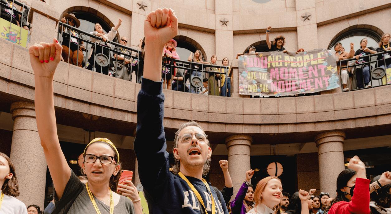 People protesting in legislature. Photo credit: CCR Studios