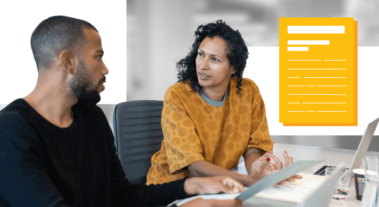 Colleagues going over their documents for a grant proposal.