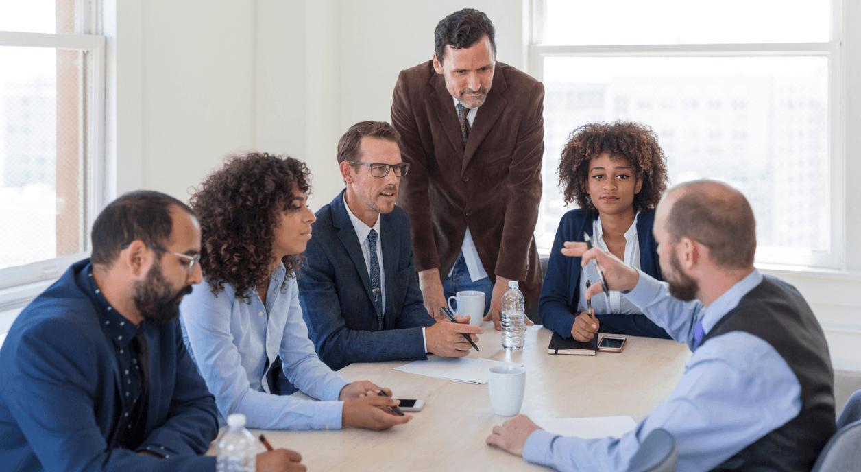 Group of major donors asking nonprofits about their impact.