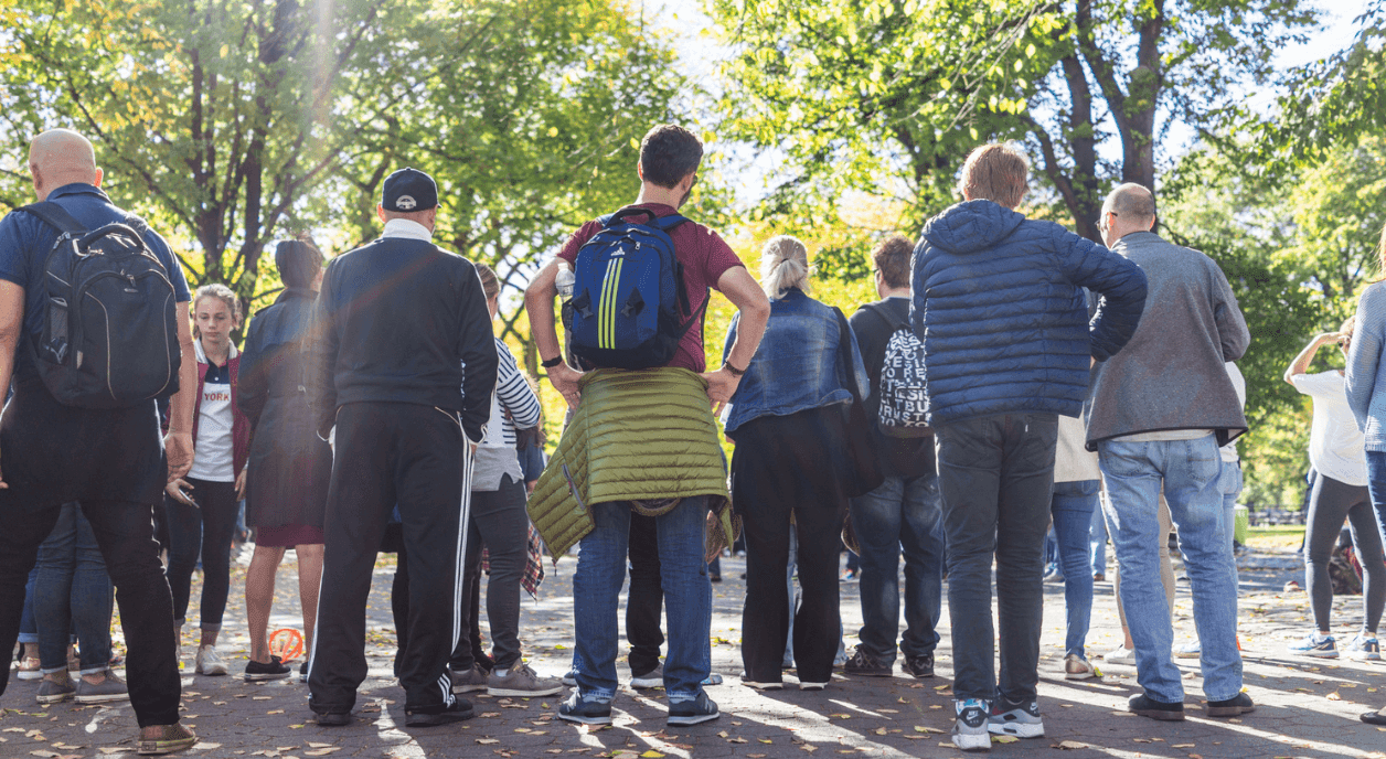 A group of people standing and watching an event occur.
