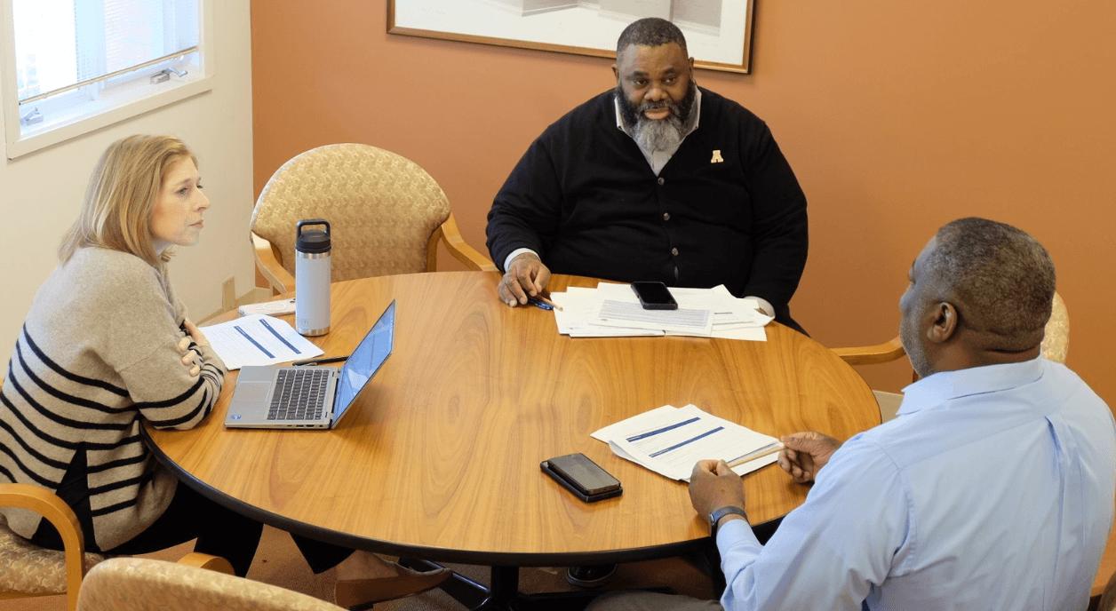 Nonprofit staff discussing how to navigate future impact.