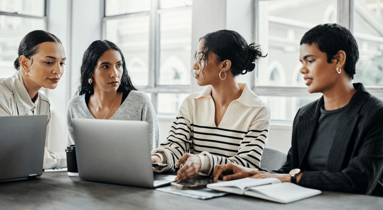 A team of diverse women dealing with nonprofit burnout.