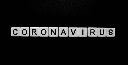 letter tiles spelling out CORONAVIRUS