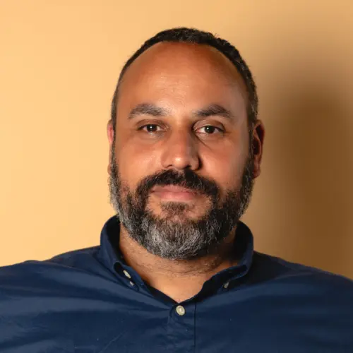 Headshot of Sean Thomas-Breitfeld, co-executive director of the Building Movement Project, in a navy blue shirt.