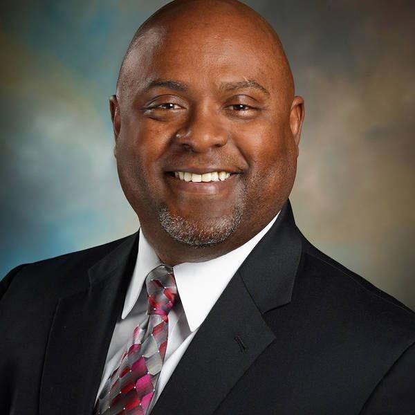 Headshot of Joe Scantlebury, President & CEO of Living Cities, in a suit and tie.