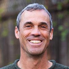 Headshot of Zach Slobig, editorial director in Bridgespan’s San Francisco office, in a dark green sweater.