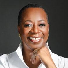 Headshot of Angela F. Williams, president and CEO of United Way Worldwide, in a white shirt.