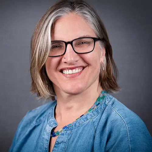 Headshot of Lisa Pilar Cowan, vice president of the Robert Sterling Clark Foundation, in glasses and a blue top.