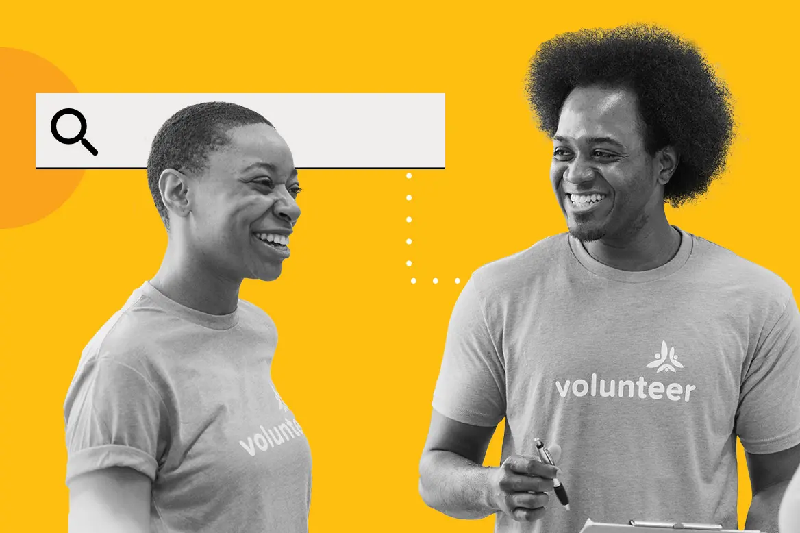 Two volunteers happily looking at Candid's data to help their nonprofit.