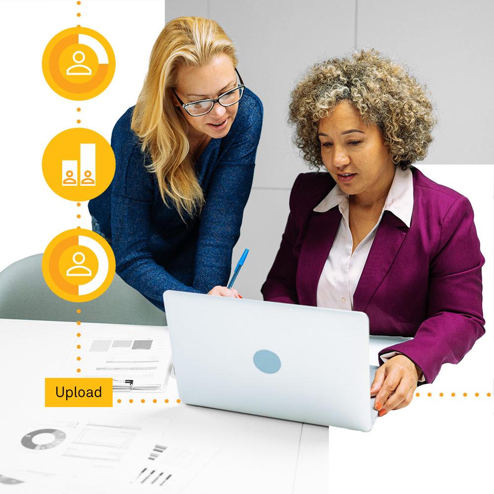 Two nonprofit professionals looking up social sector initiatives on their laptop.