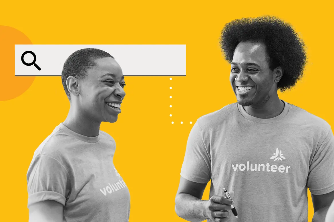 Two volunteers happily looking at Candid's data to help their nonprofit.