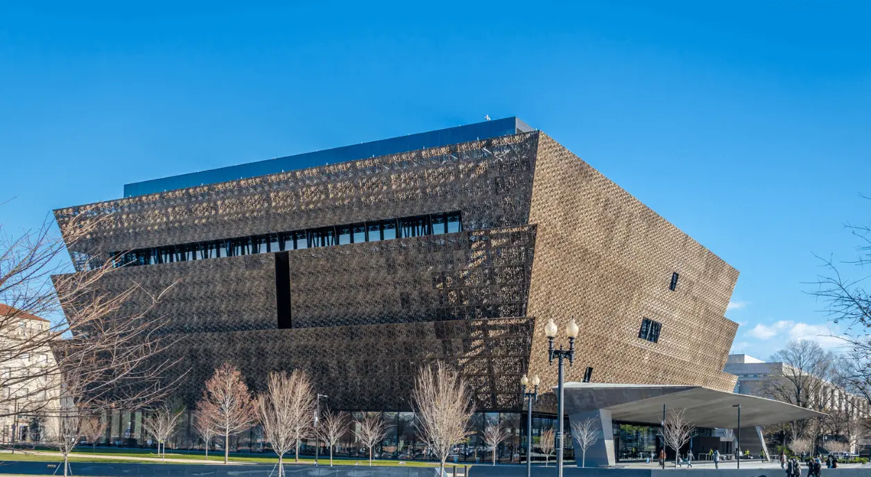 The National Museum of African American History and Culture against a blue sky background. Photo credit diegograndi/Getty Images.