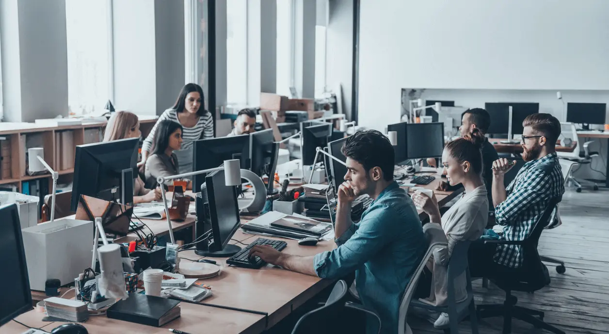A group of nonprofit employees in an open office setting.