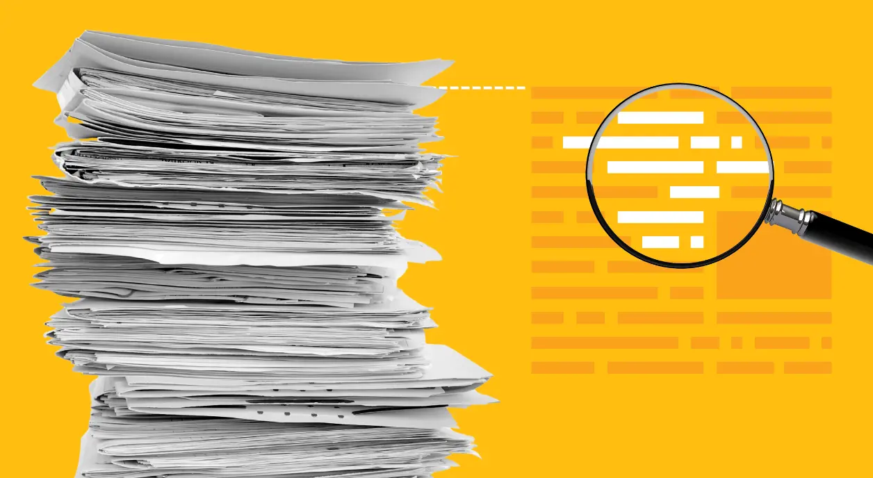 A stack of research papers being magnified.