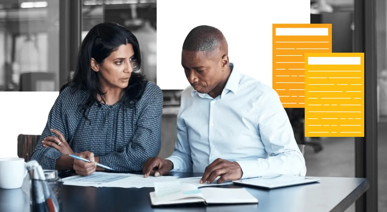 Nonprofit colleagues looking over their grant proposal documents.