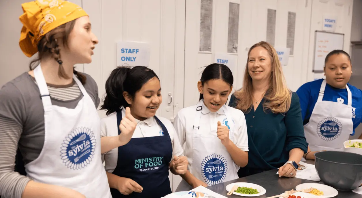 Young students working in a food kitchen.