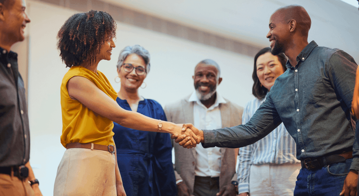 Fiscal sponsor and nonprofit worker shaking hands.