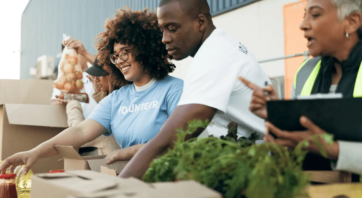 Volunteers and nonprofit staff working together to sort groceries.