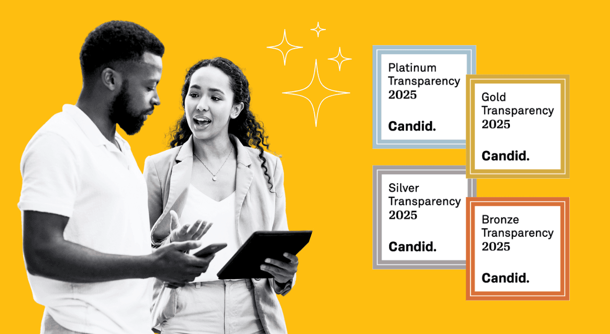 Two nonprofit workers look at their Candid nonprofit profile to earn a Seal of Transparency.