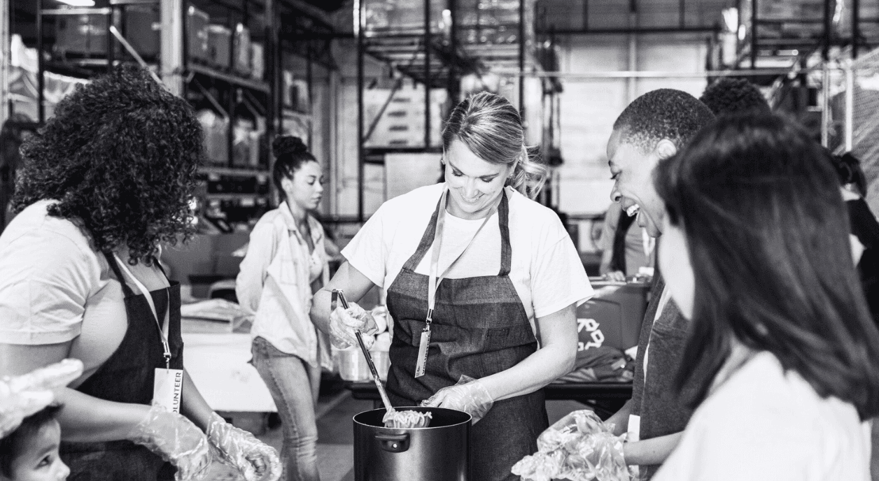 Four people volunteering at a soup kitchen.
